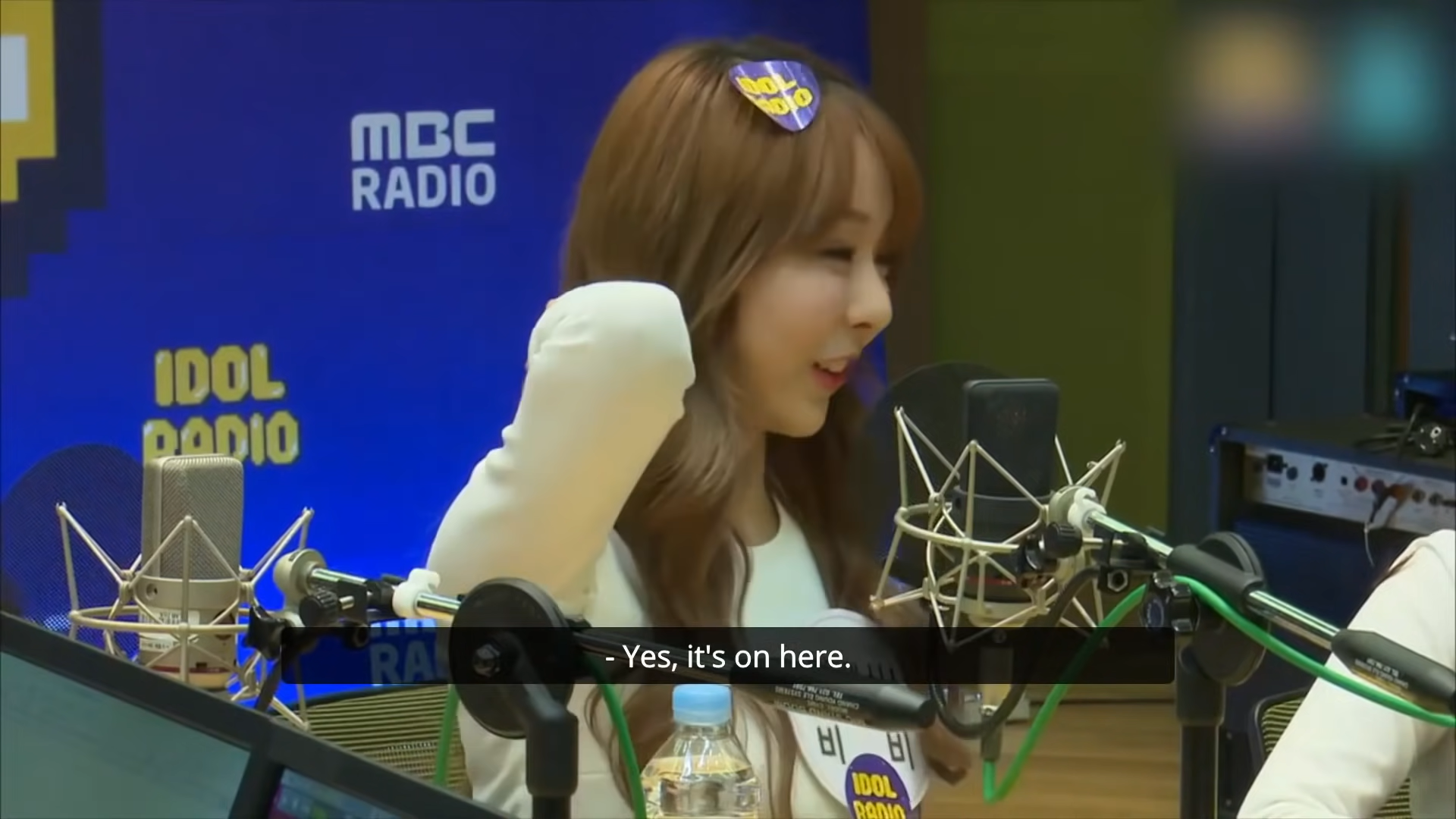 Vivi says 'Yes, it's on here' and gestures to the back of her neck.